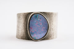 Close-up of Oxidized Opal Doublet Adjustable Ring showing violet blue play-of-colour and hand-textured silver band.