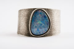 Group of Oxidized Opal Doublet Adjustable Rings shown on white background with wide textured sterling silver bands.