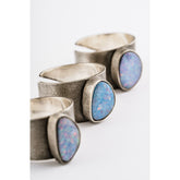 Oxidized Opal Doublet Adjustable Ring shown on white background with textured sterling silver band and colourful Opal stones.
