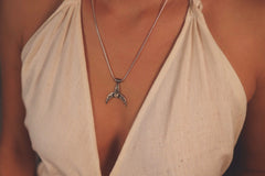 Crescent Whale Moonstone pendant worn on a model as an ocean-inspired sterling silver necklace.