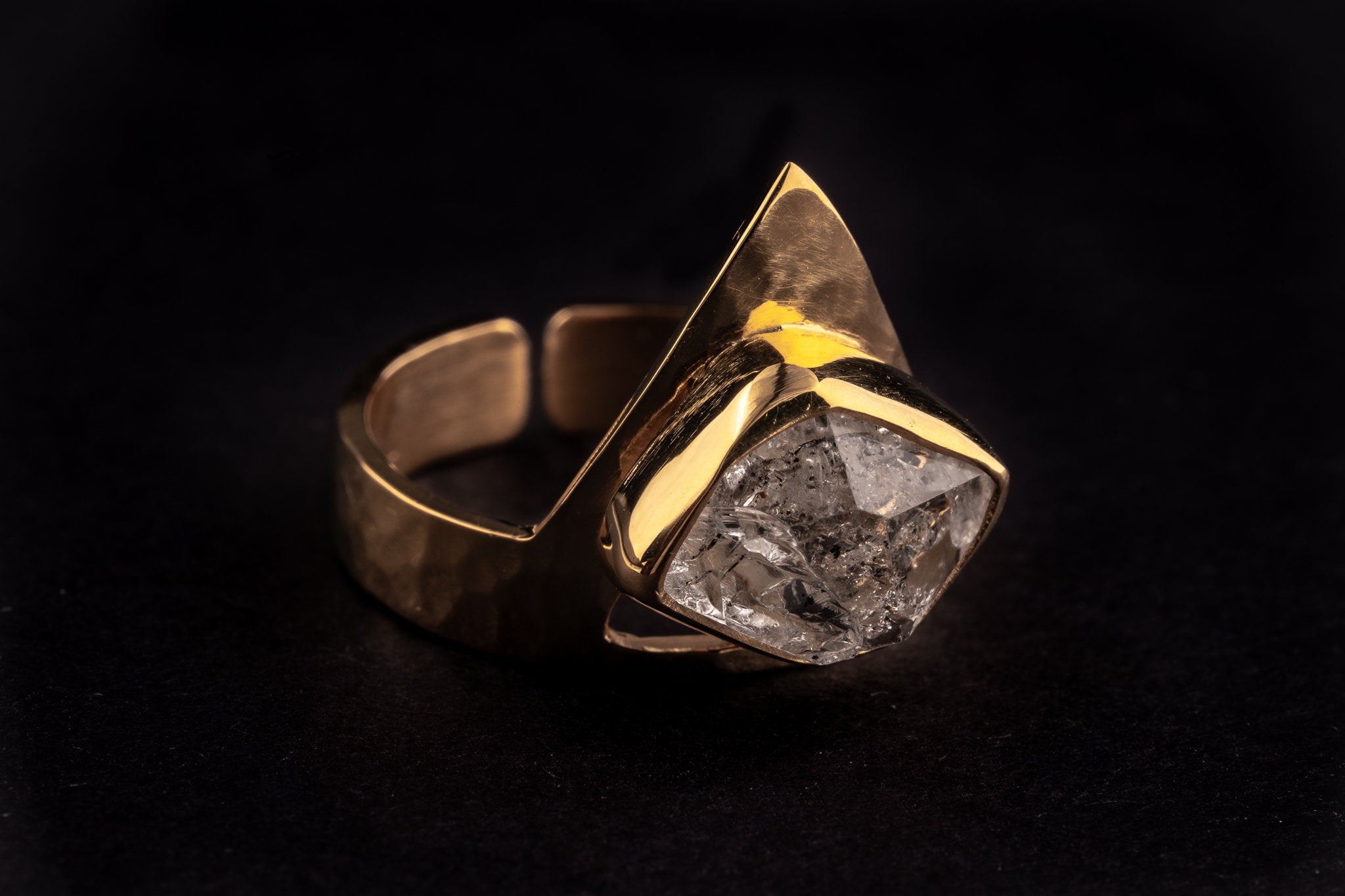 Golden Herkimer Diamond Pyramid Ring shown on black background with 18k gold plated silver and raw Quartz crystal.