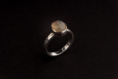 Purple Labradorite Silver Ring shown worn on finger with soft purple feldspar flash and handmade silver bezel.