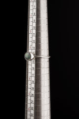 Lightning Ridge Black Opal ring shown on a mandrel for size reference, appearing around US size 6.5 to 7.