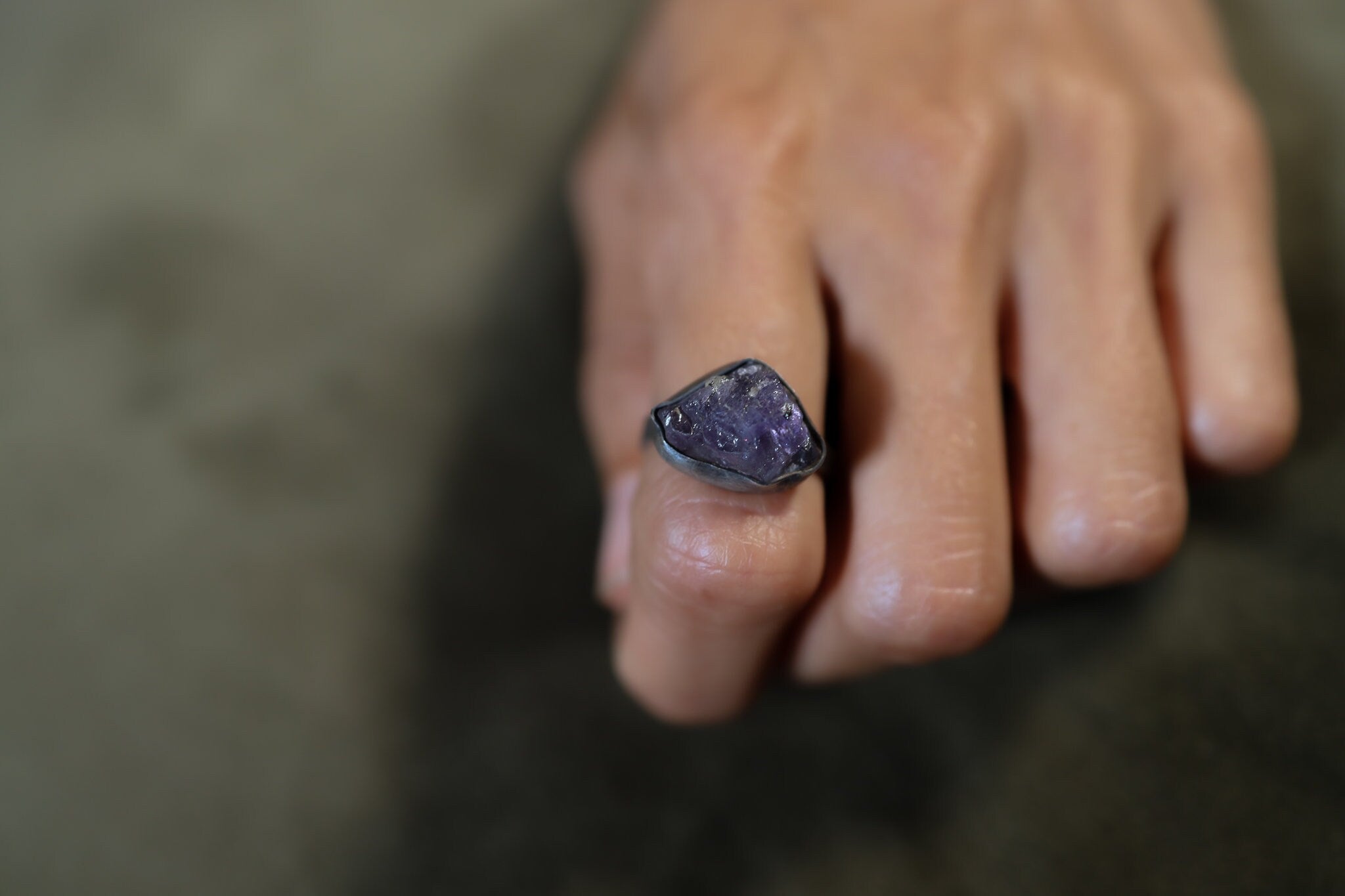 Raw Tanzanite Silver Ring shown worn outdoors with vivid blue-violet gemstone and hammered 925 silver.
