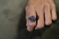 Raw Tanzanite Silver Ring shown worn outdoors with vivid blue-violet gemstone and hammered 925 silver.
