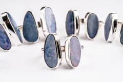 Australian Opal Doublet Adjustable Rings shown on white background with vintage cut opals and polished silver bands.