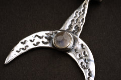 Close-up of Moon Whale pendant showing hammered silver texture and Blue Moonstone accent.