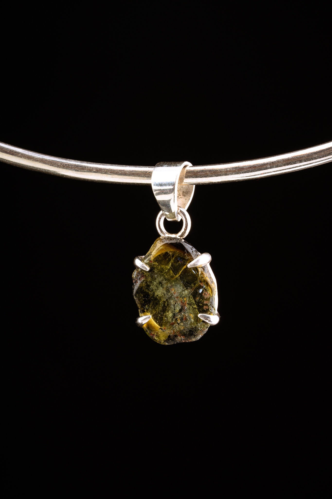 Verdelite Green Tourmaline pendant displayed on silver choker against black background.
