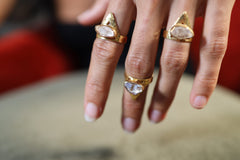 Golden Herkimer Diamond Pyramid Ring shown worn on hand with triangular gold plated setting and raw clear crystal.