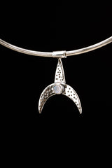 Crescent Whale Moonstone pendant displayed on black background with oxidized sterling silver and blue Moonstone accent.