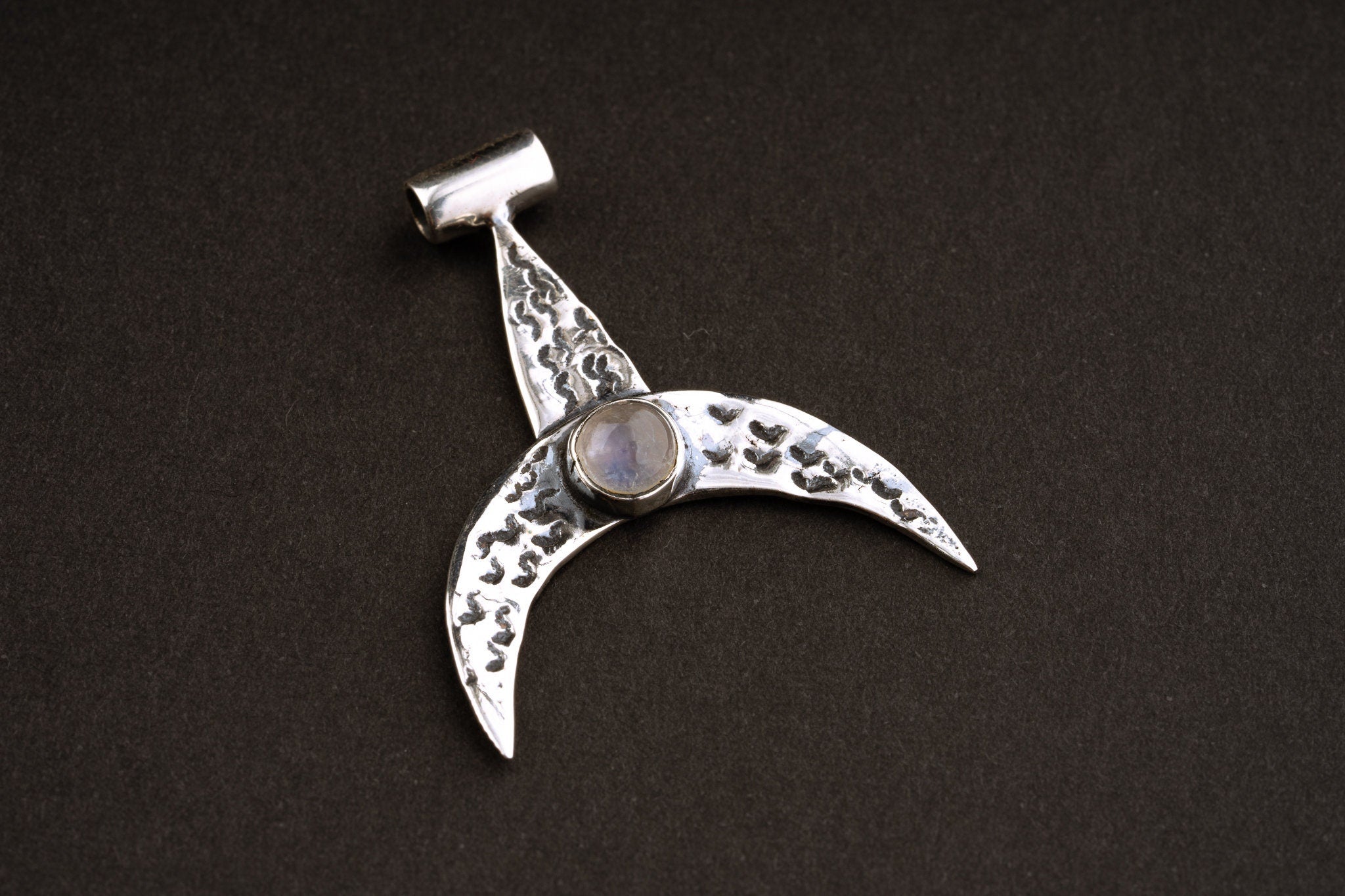Moon Whale Blue Moonstone pendant shown on dark background with oxidized sterling silver crescent shape.