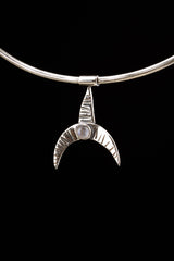 Crescent moon whale fin pendant displayed on a choker with Blue Moonstone and oxidized sterling silver texture.