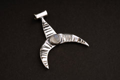 Crescent Whale Moonstone pendant shown on dark background with oxidized sterling silver and Blue Moonstone accent.