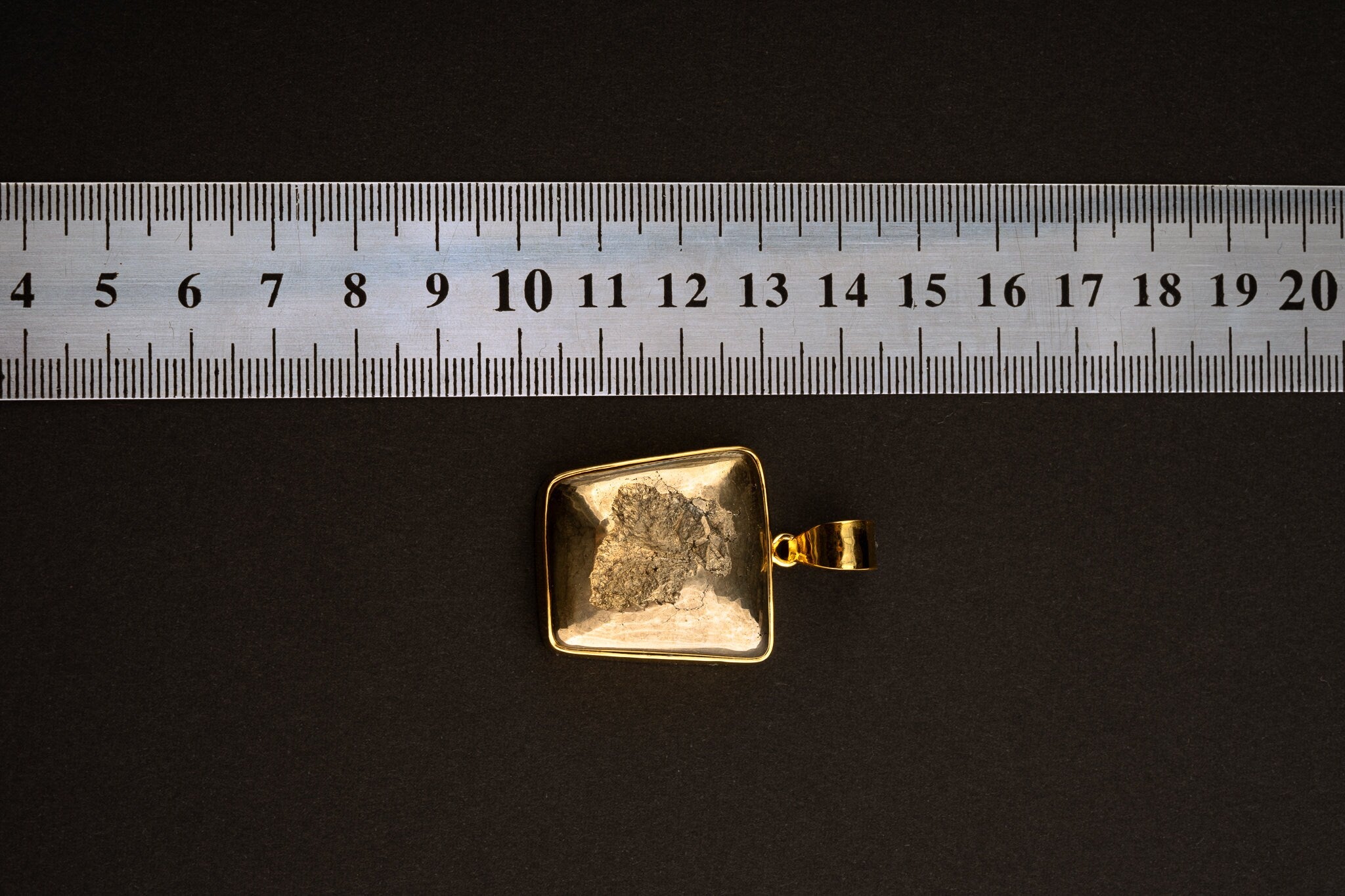 Natural Cubic Pyrite pendant shown beside a ruler for scale, measuring approximately 3.5 cm total length including bail.