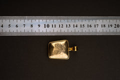 Natural Cubic Pyrite pendant shown beside a ruler for scale, measuring approximately 3.5 cm total length including bail.
