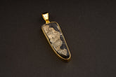 Gold-plated 925 sterling silver pendant with a natural cubic Pyrite specimen, hammered bezel setting, and sculptural coiled bail.