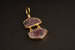 Raw Ruby record keeper double pendant with two linked stones, gold-plated silver caps, wide bail, and earthy red mineral texture.