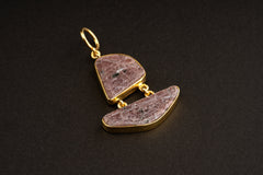 Double raw Ruby pendant shown worn on a necklace, with two linked stones, gold-plated caps, and compact drop shape.