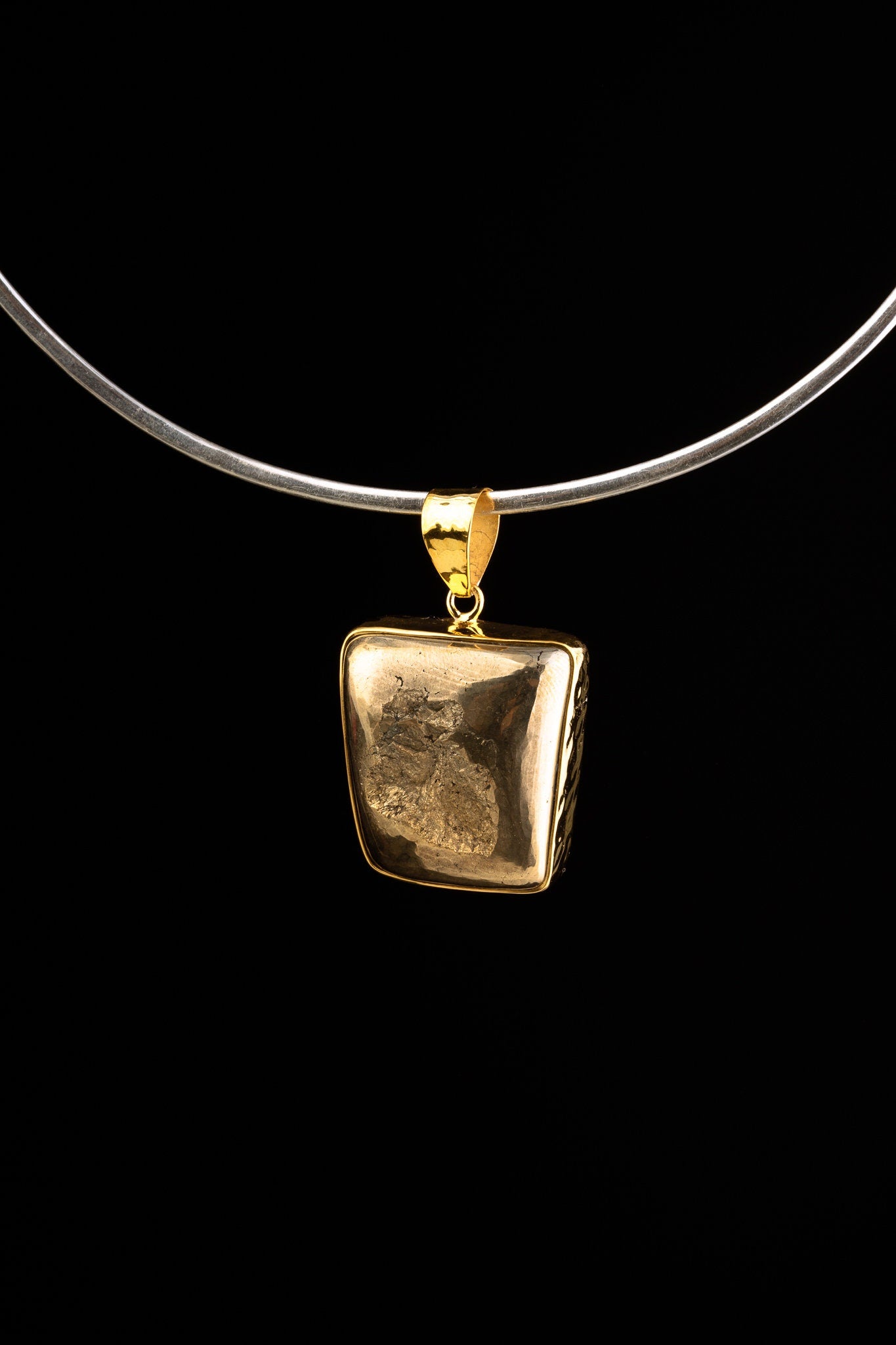 Gold-plated 925 sterling silver pendant with a natural Cubic Pyrite specimen, hammered bezel cap, and sculptural coiled bail.