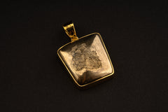 Square natural Cubic Pyrite pendant shown on a necklace, with gold-plated sterling silver setting and compact mineral shape.