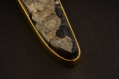 Detail view of natural Pyrite specimen in a gold-plated sterling silver bezel, showing golden mineral texture and dark matrix contrast.