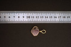 Raw Indian Ruby pendant shown beside a ruler for scale, measuring approximately 2.7 to 3 cm total length including bail.
