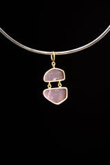 Double raw Ruby pendant shown worn on a necklace, with two linked stones, gold-plated caps, and compact drop shape.