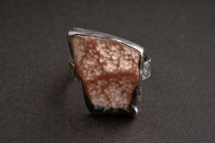 Front view of handmade Rhodochrosite ring showing pink rose mineral patterning and a secure sterling silver setting.