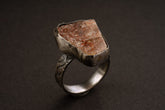 Handmade 925 sterling silver Sunstone ring shown on a dark background, with warm orange gemstone and sturdy silver band.