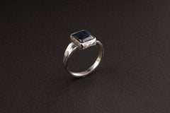 Side view of Tanzanite ring showing oxidized sterling silver texture, raised bezel setting, and masculine profile.