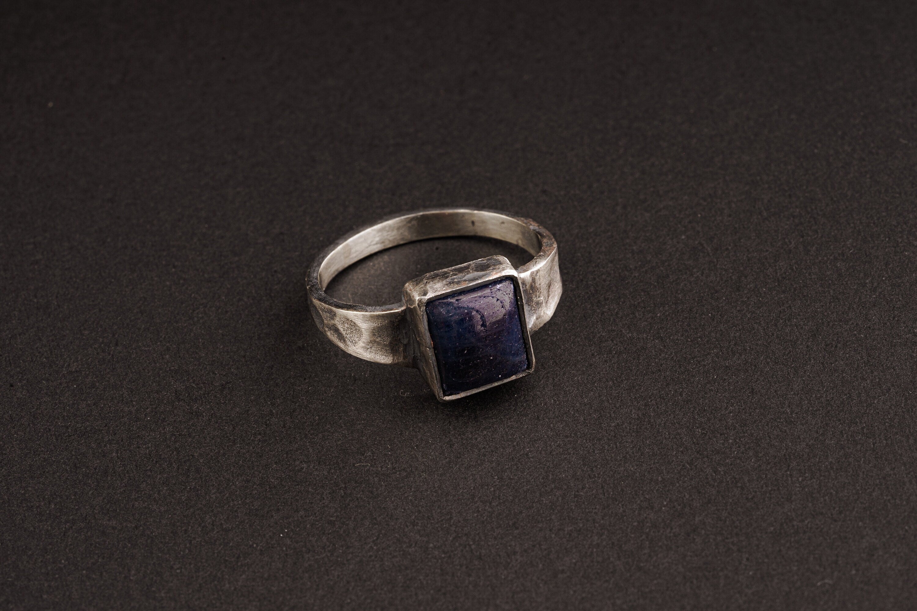 Tanzanite ring in oxidized 925 sterling silver with textured band and blue-violet gemstone set in a solid bezel.