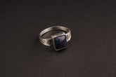 Tanzanite ring in oxidized 925 sterling silver with textured band and blue-violet gemstone set in a solid bezel.