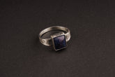 Tanzanite ring in oxidized 925 sterling silver with textured band and blue-violet gemstone set in a solid bezel.