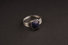 Tanzanite ring in oxidized 925 sterling silver with textured band and blue-violet gemstone set in a solid bezel.