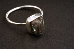 Side view of rough Watermelon Tourmaline ring showing the raised raw stone, revealing bezel setting, and fine silver band.