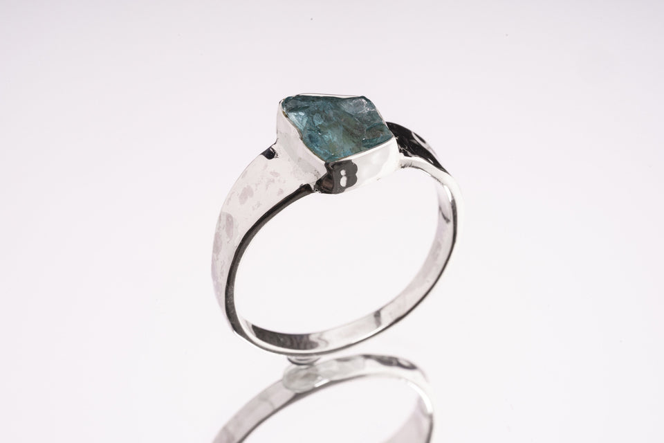 Blue Apatite Textured Silver Ring shown from the side with hand-textured sterling silver band and raised blue stone.