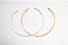 Gold and sterling silver open collar chokers shown side by side as minimal layering necklace options.