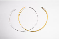 Gold and sterling silver open collar chokers shown side by side as minimal layering necklace options.