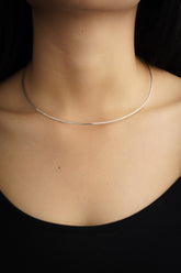 Sterling silver open collar choker shown worn on a model as a minimal handmade necklace.
