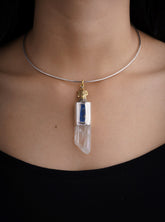 Himalayan Twin Quartz Kyanite Rooster pendant shown worn on the chest with brushed sterling silver and brass detail.