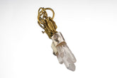 Buddha Twin Quartz Herkimer Diamond pendant shown on a white background with brushed sterling silver and brass figure detail.
