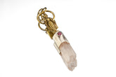 Buddha Clear Quartz Ruby talisman pendant shown worn on a model, with mixed-metal setting and clear crystal point.