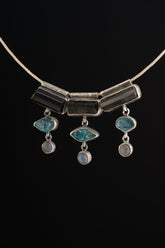 Grounding Vision Stack Pendant with Black Tourmaline, Blue Apatite, and Labradorite in oxidized sterling silver, shown on black cord.