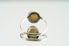 Front view of Ethiopian Opal ring showing soft luminous body tone, subtle play-of-colour, and secure sterling silver setting.