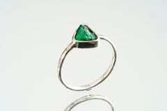 Front view of handmade Emerald ring showing bright green beryl colour, secure sterling silver setting, and solid band.