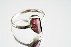 Pink Tourmaline sterling silver ring shown on a light background, with a deep rose gemstone and handmade silver setting.