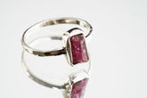 Handmade 925 sterling silver Pink Tourmaline ring shown worn on the hand, with a deep rose gemstone and solid silver band.