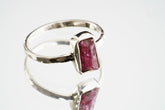 Handmade 925 sterling silver Pink Tourmaline ring shown worn on the hand, with a deep rose gemstone and solid silver band.
