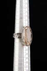Rutilated Quartz ring shown beside a ruler for scale, with oval stone and oxidized 925 sterling silver construction.