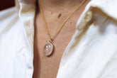 Organic Rose Quartz pendant shown worn on a necklace, with 18k gold-plated sterling silver and soft pink stone glow.